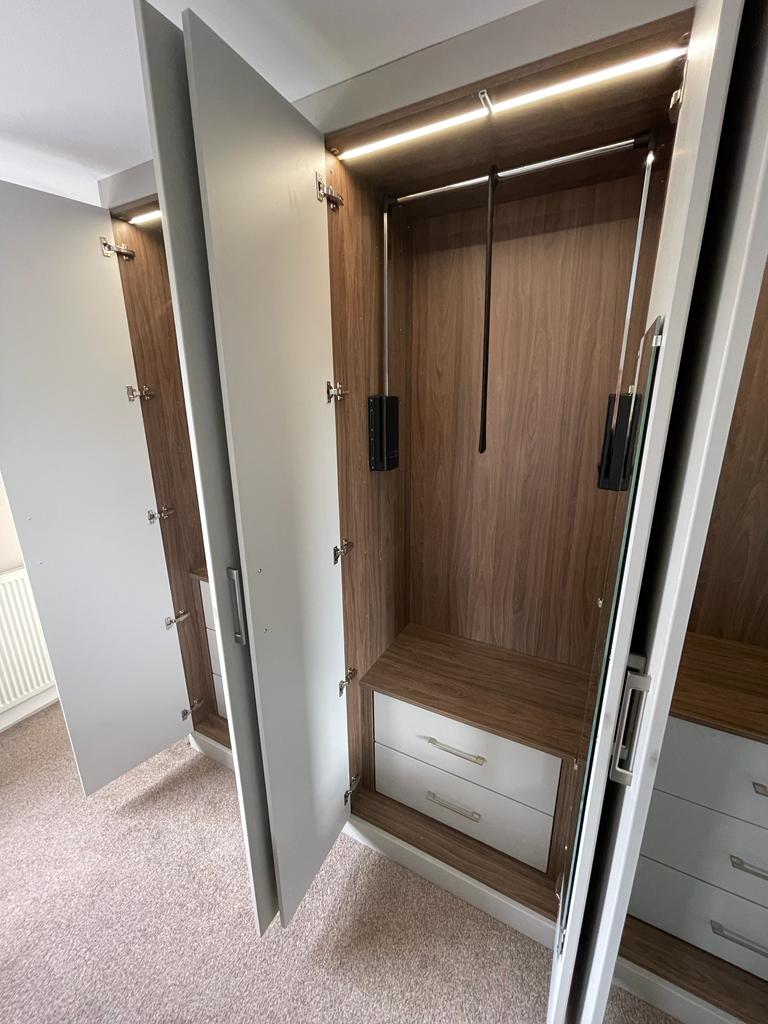 Fitted bedroom furniture with fitted wardrobes in North Stainley, Harrogate Features flush modern style door finished in Matt dove grey, walnut effect interiors with integrated lighting7